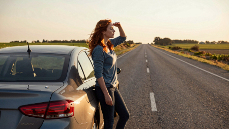 woman stranded on deserted highway at sunset generated with Z-Image